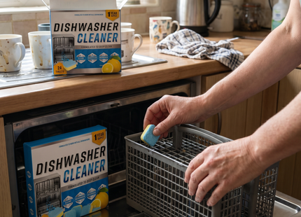 Person placing a WSGenie dishwasher cleaner tablet into a dishwasher