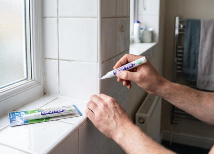 Person whitening tile grout with the WSGenie tile grout marker pen